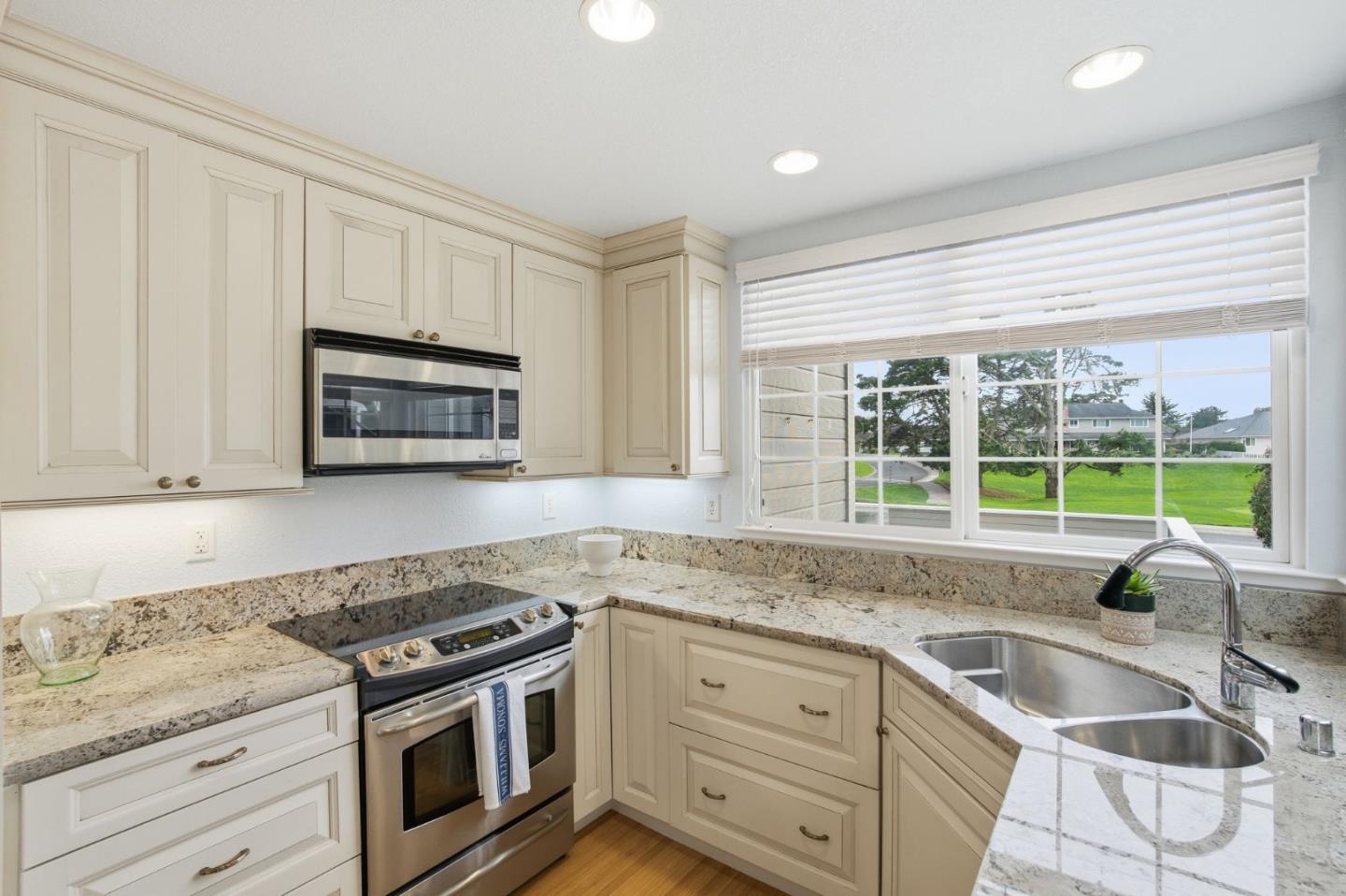 25 Merion Road Half Moon Bay, CA 94019 - Photo 12 of 72 a kitchen with granite countertop white cabinets and a sink