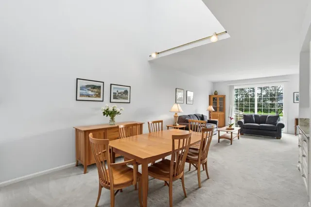a bathroom with a granite countertop sink toilet and mirror