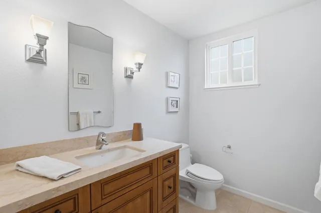 a bathroom with double vanity sinks and a large mirror