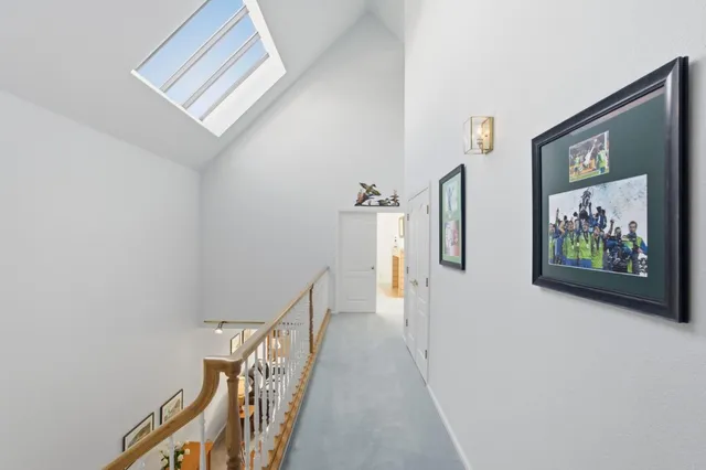 a bedroom with a bed and a lamp on dresser