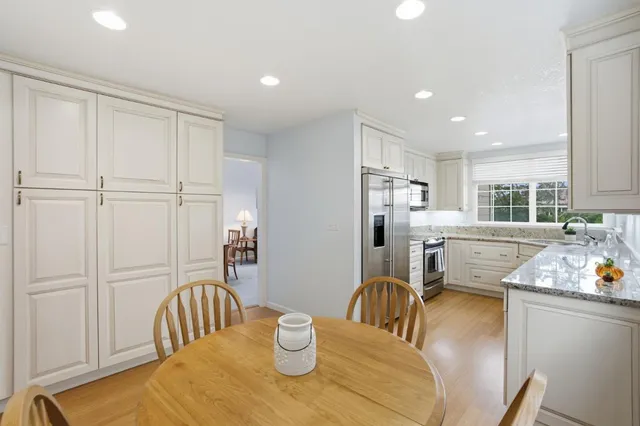 a kitchen with granite countertop white cabinets and a sink