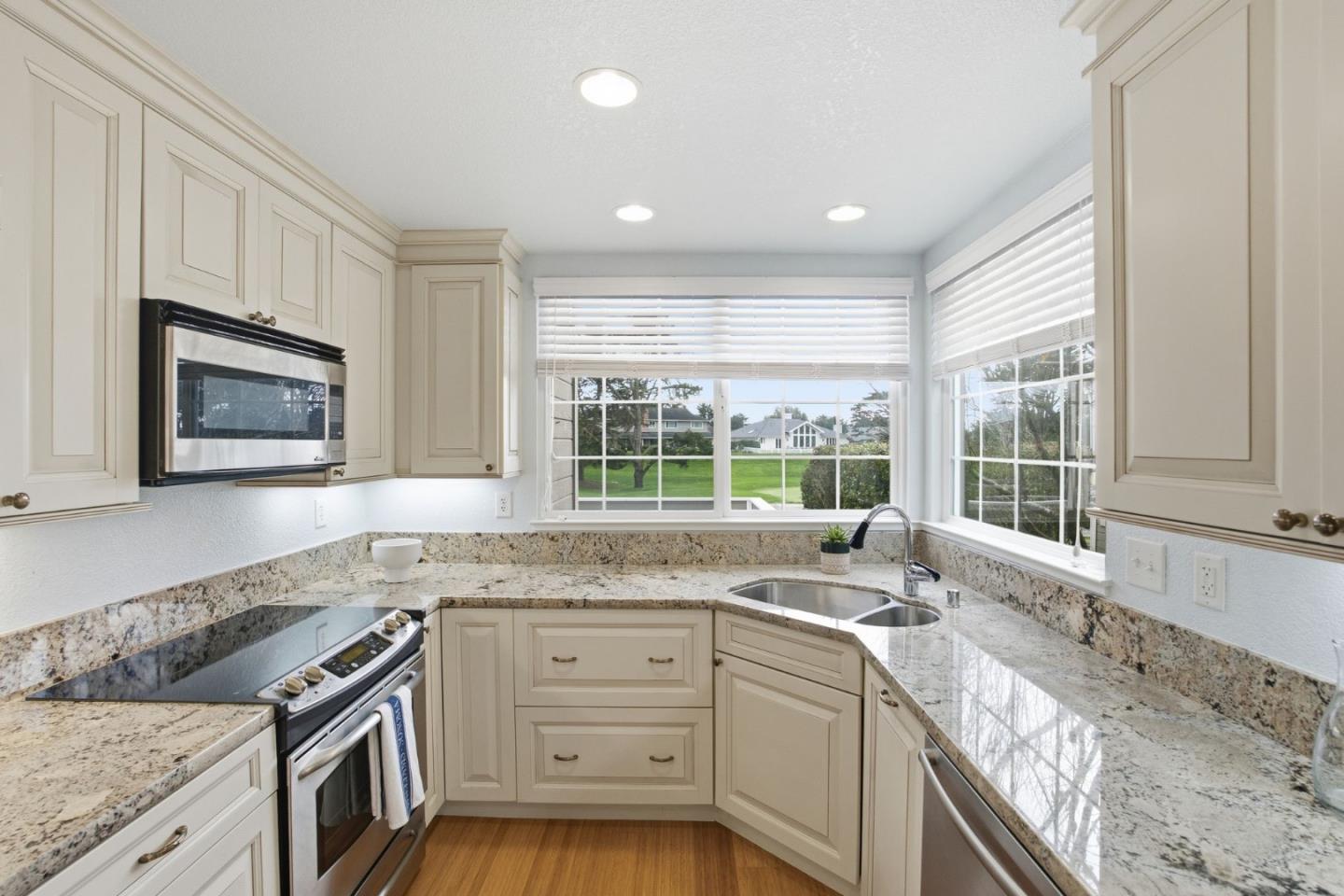 25 Merion Road Half Moon Bay, CA 94019 - Photo 10 of 72 a kitchen with granite countertop a sink stove and cabinets
