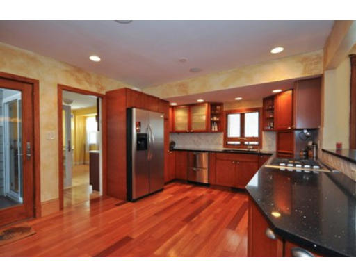 64 Wyoming Road Newton, MA 02460 - Photo 3 of 29 a kitchen with stainless steel appliances dining table and chairs