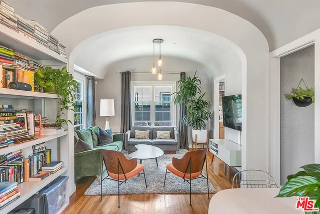 a living room with fireplace furniture and a potted plant