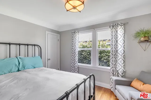 a bedroom with a bed and a couch