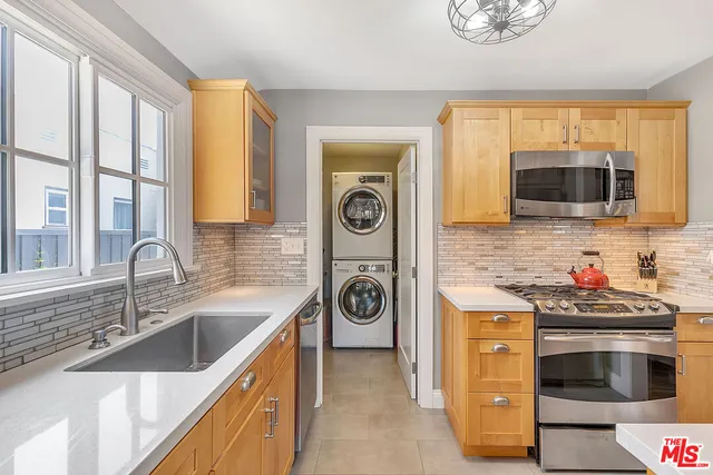 a kitchen with stainless steel appliances granite countertop a stove and a sink