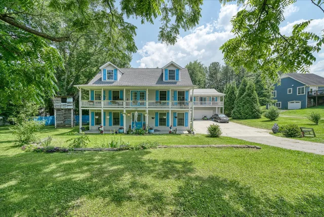 a view of a house with a yard and sitting area
