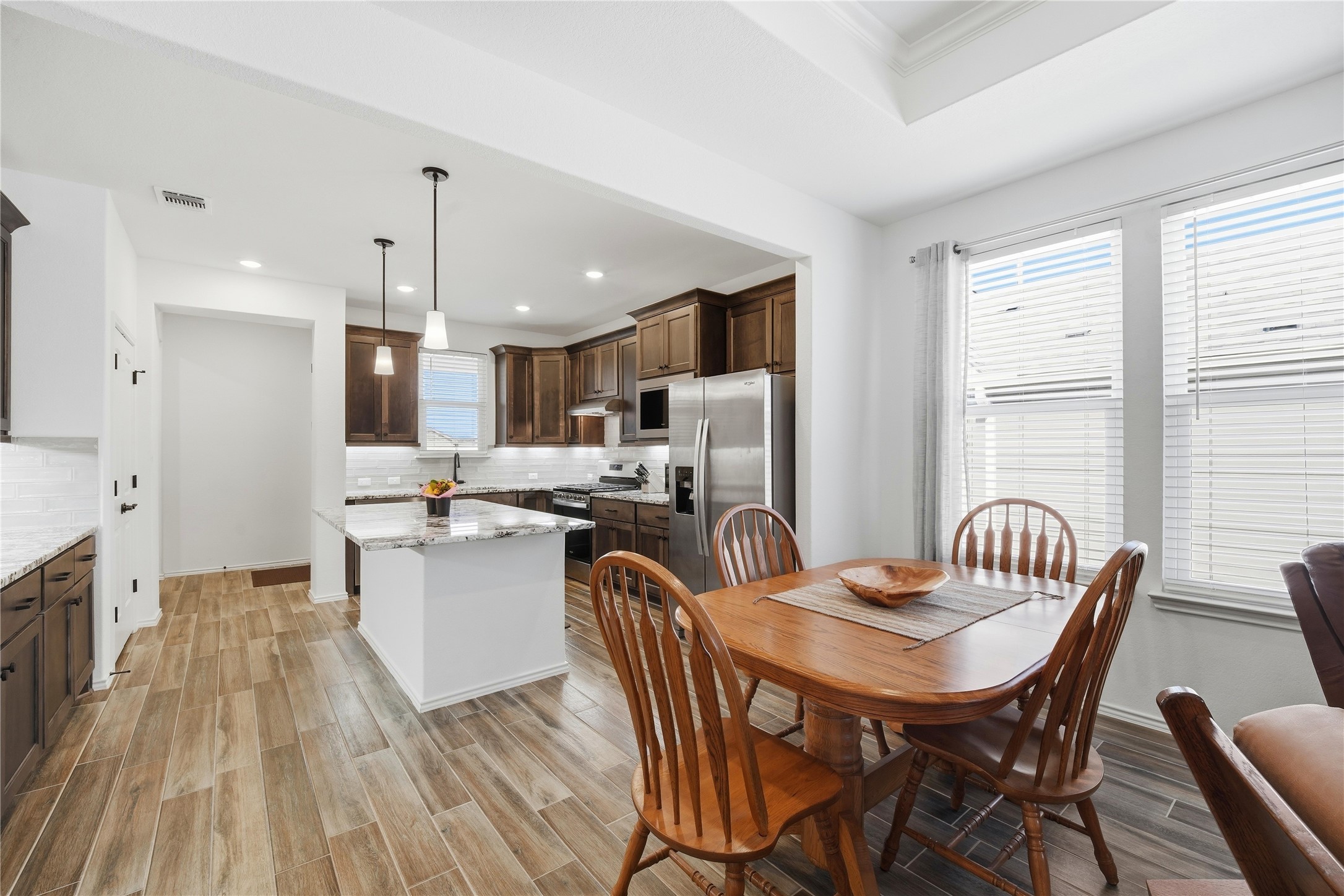 122 Clay Hl Street Georgetown, TX 78633 - Photo 12 of 31 Dining space with wood finish floors, recessed lighting, and ornamental molding