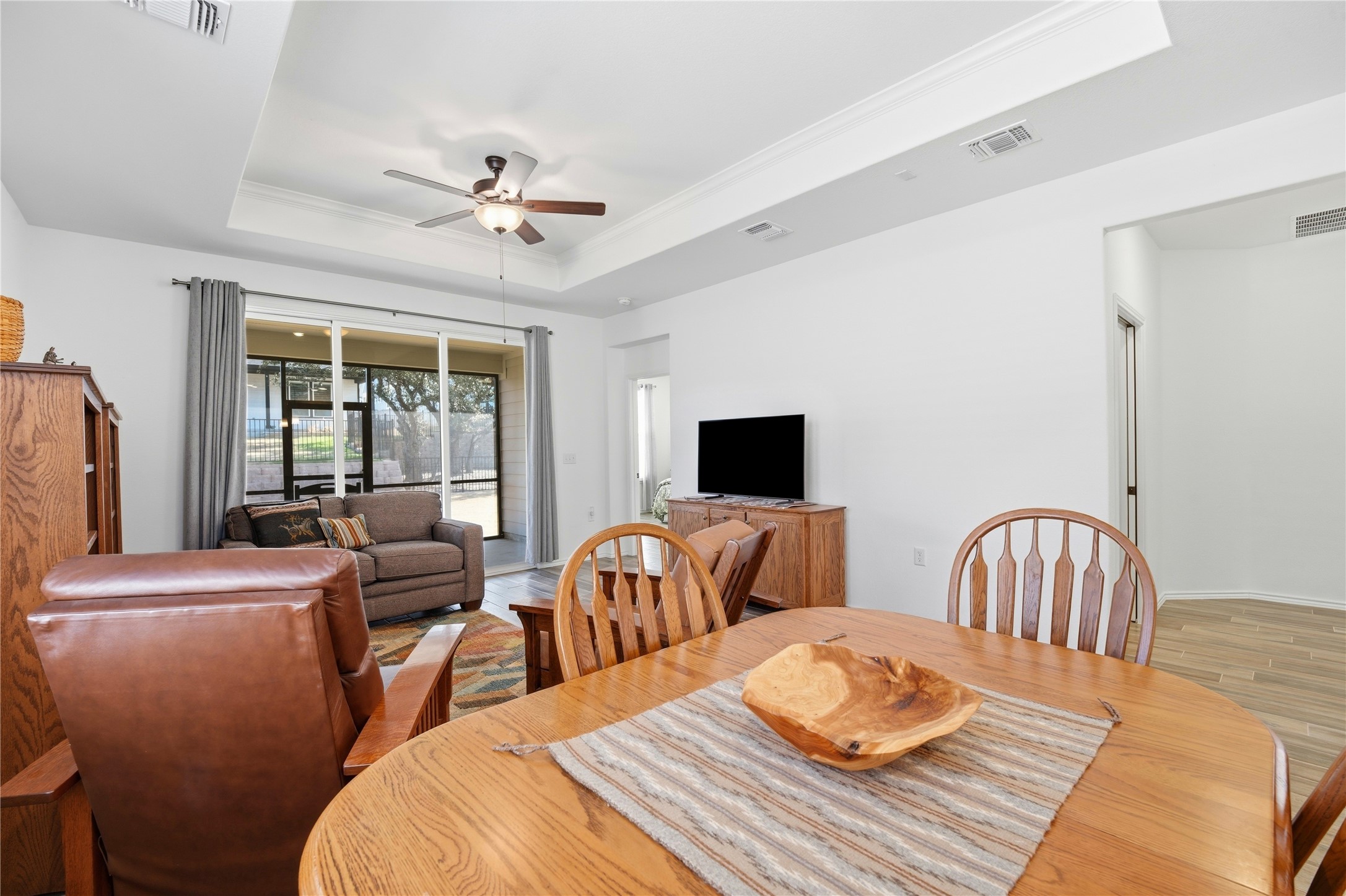 122 Clay Hl Street Georgetown, TX 78633 - Photo 13 of 31 Dining space with a ceiling fan, light wood-type flooring, and a raised ceiling