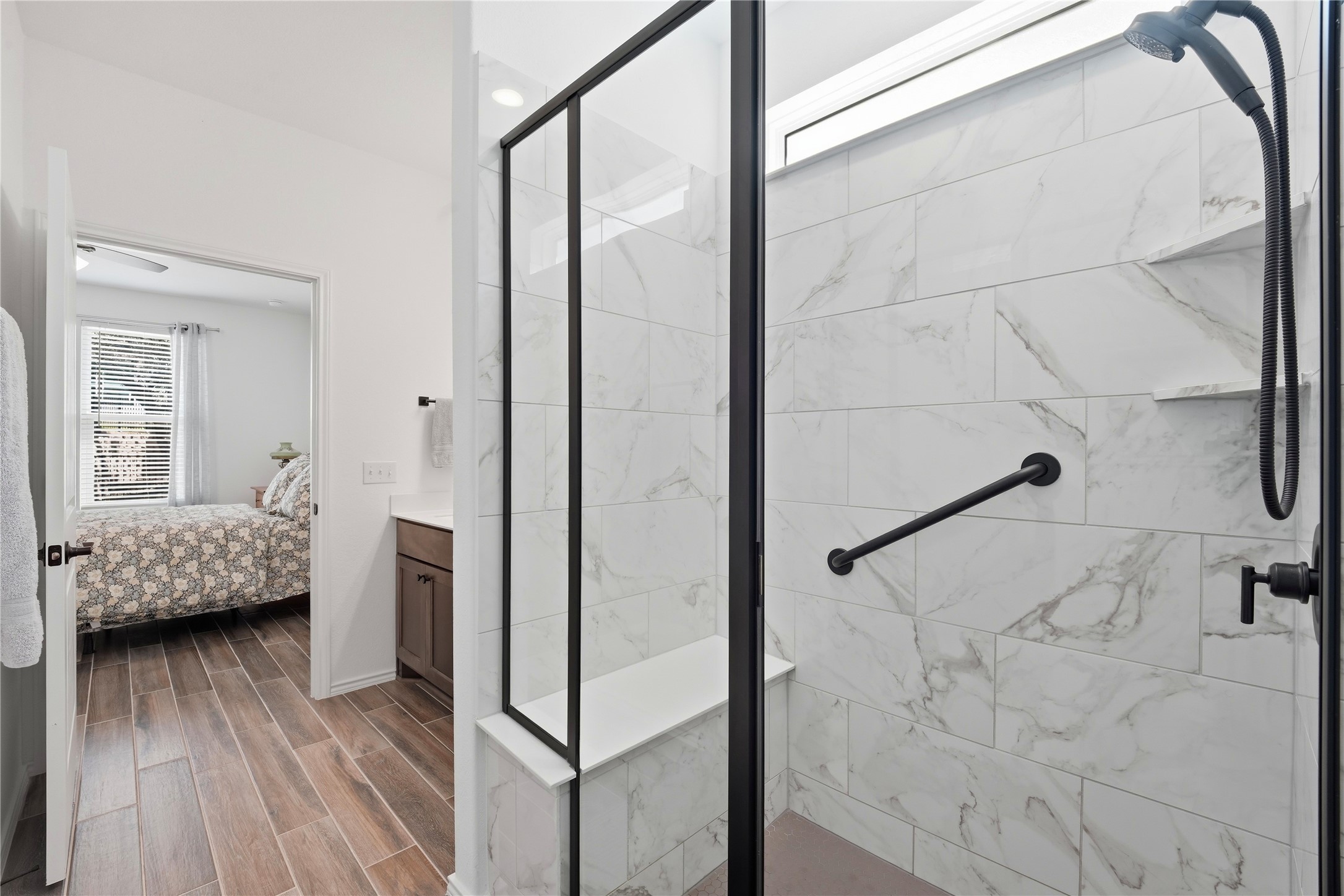 122 Clay Hl Street Georgetown, TX 78633 - Photo 18 of 31 Bathroom with a marble finish shower, wood finish floors, ensuite bath, and vanity