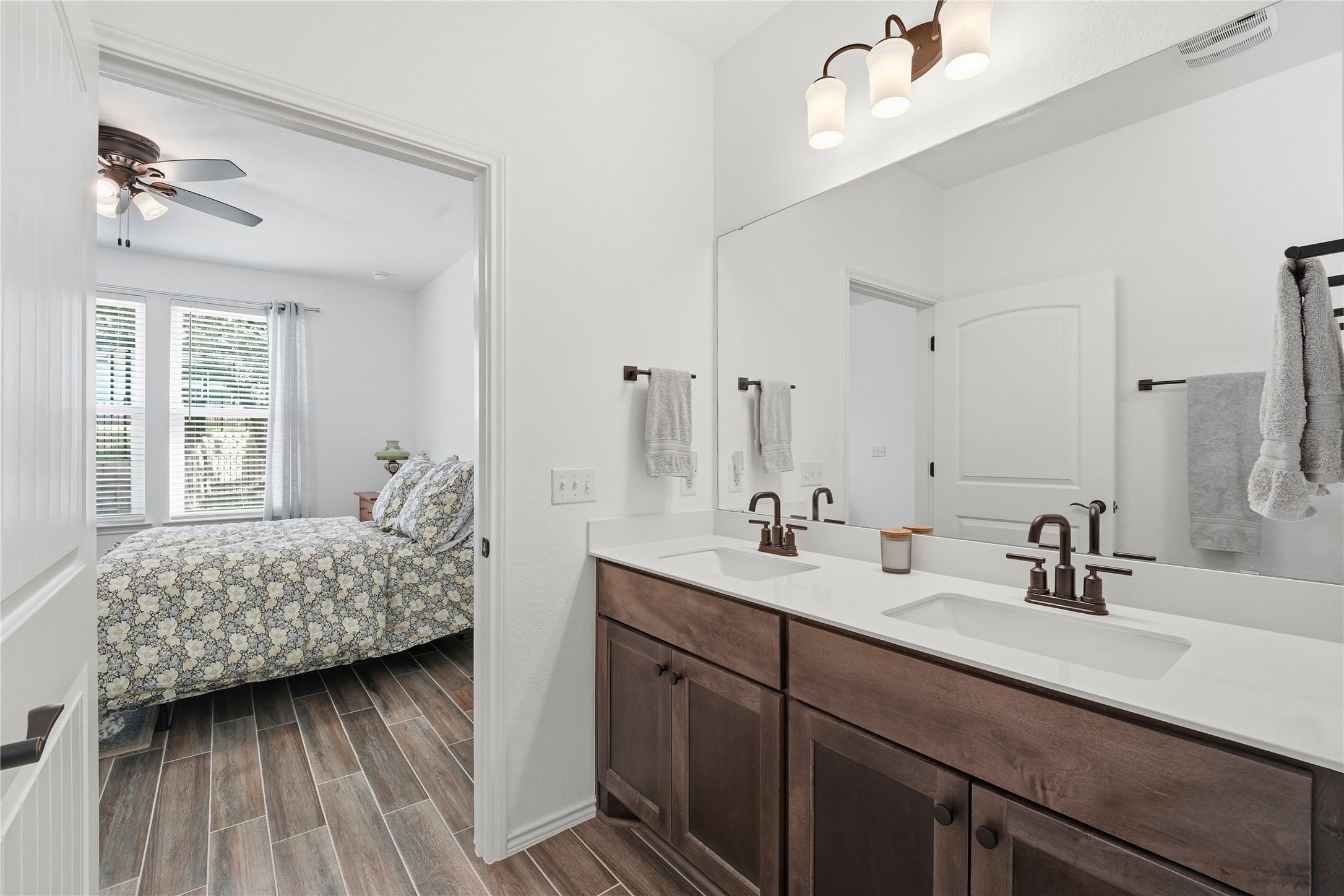 122 Clay Hl Street Georgetown, TX 78633 - Photo 19 of 31 Full bathroom with ensuite bath, wood finish floors, double vanity, and ceiling fan