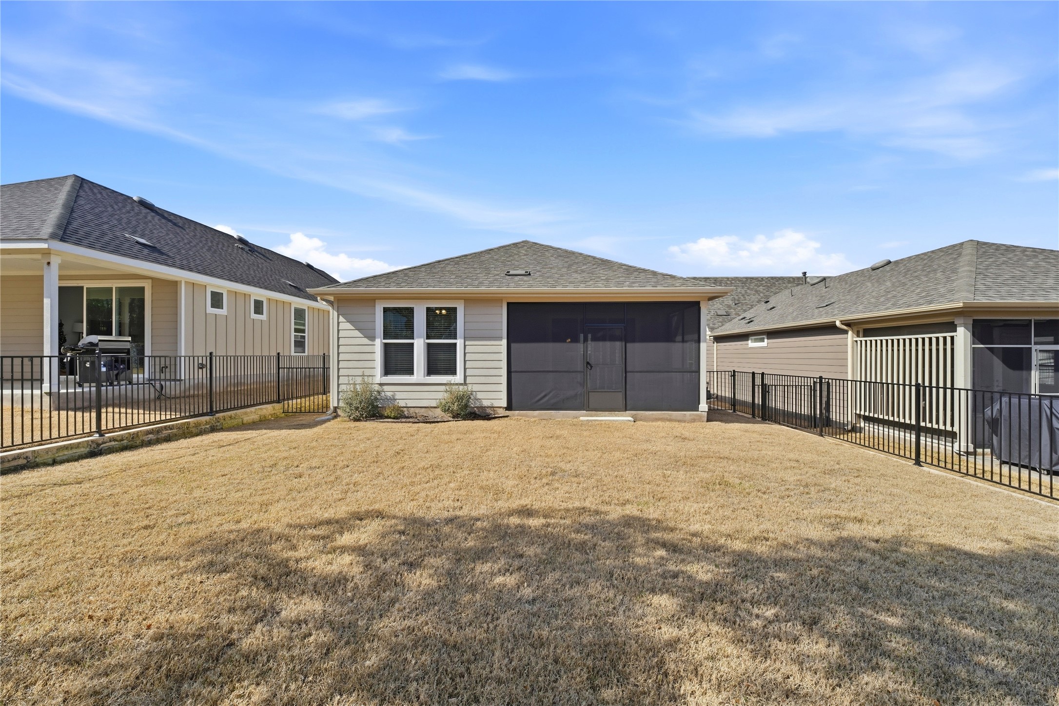 122 Clay Hl Street Georgetown, TX 78633 - Photo 25 of 31 Back of property featuring a fenced backyard, a sunroom, and roof with shingles