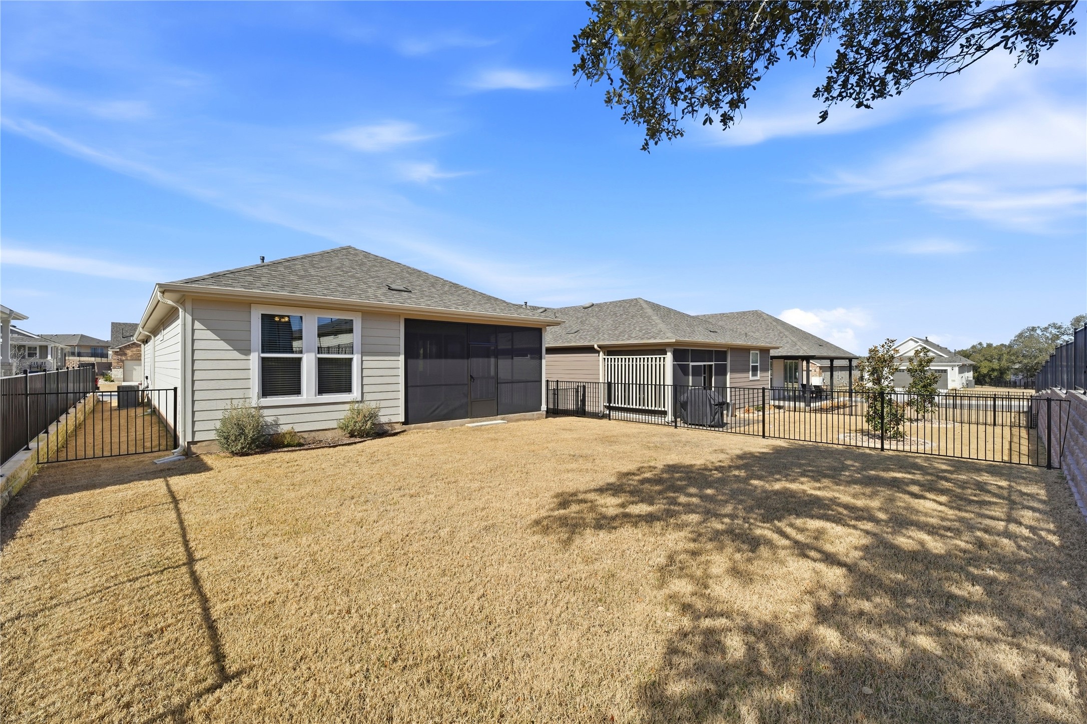 122 Clay Hl Street Georgetown, TX 78633 - Photo 26 of 31 Rear view of house with a fenced backyard, a garage, and roof with shingles