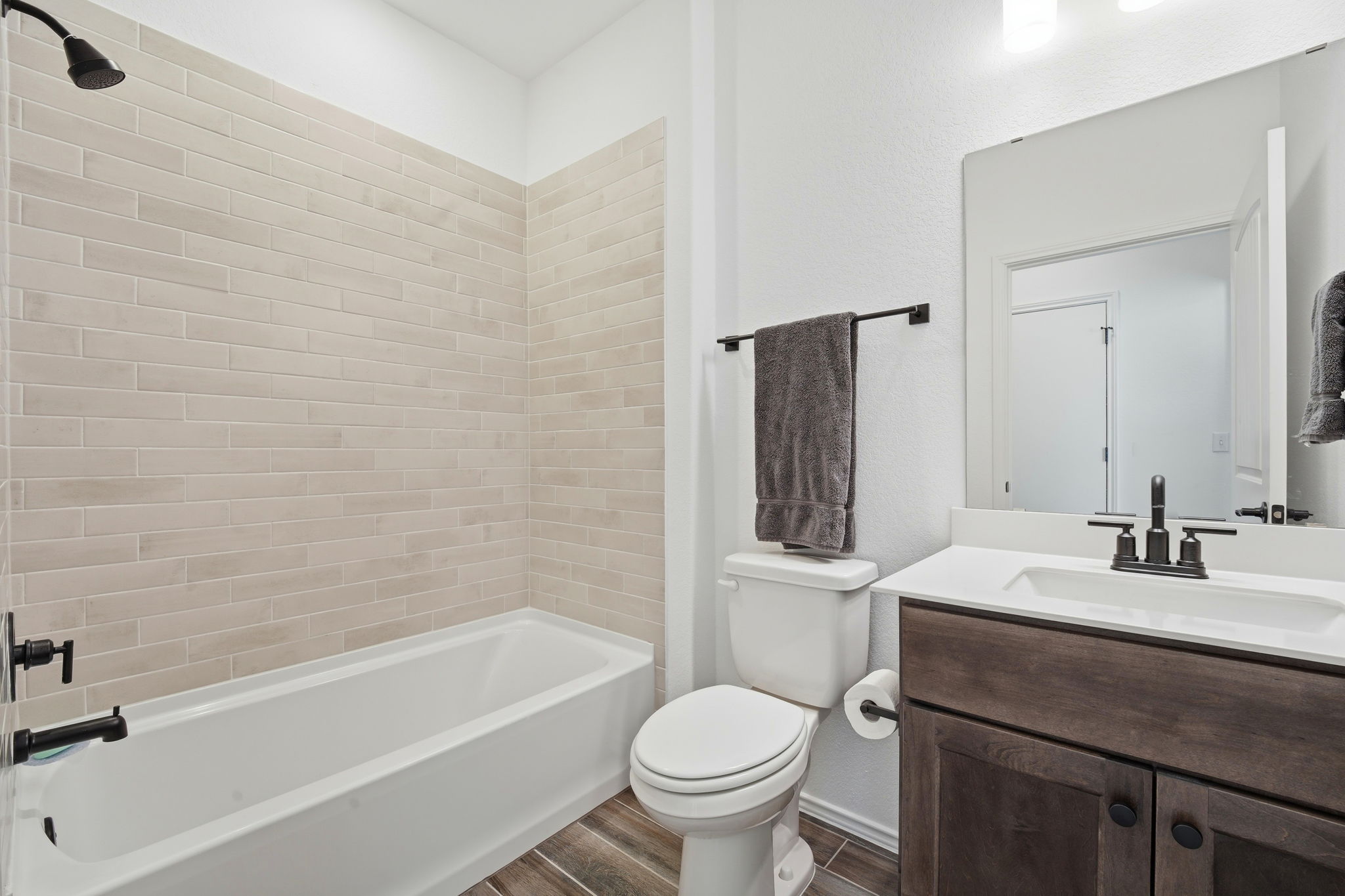 122 Clay Hl Street Georgetown, TX 78633 - Photo 28 of 31 Bathroom featuring vanity, wood tiled floors, and bathtub / shower combination