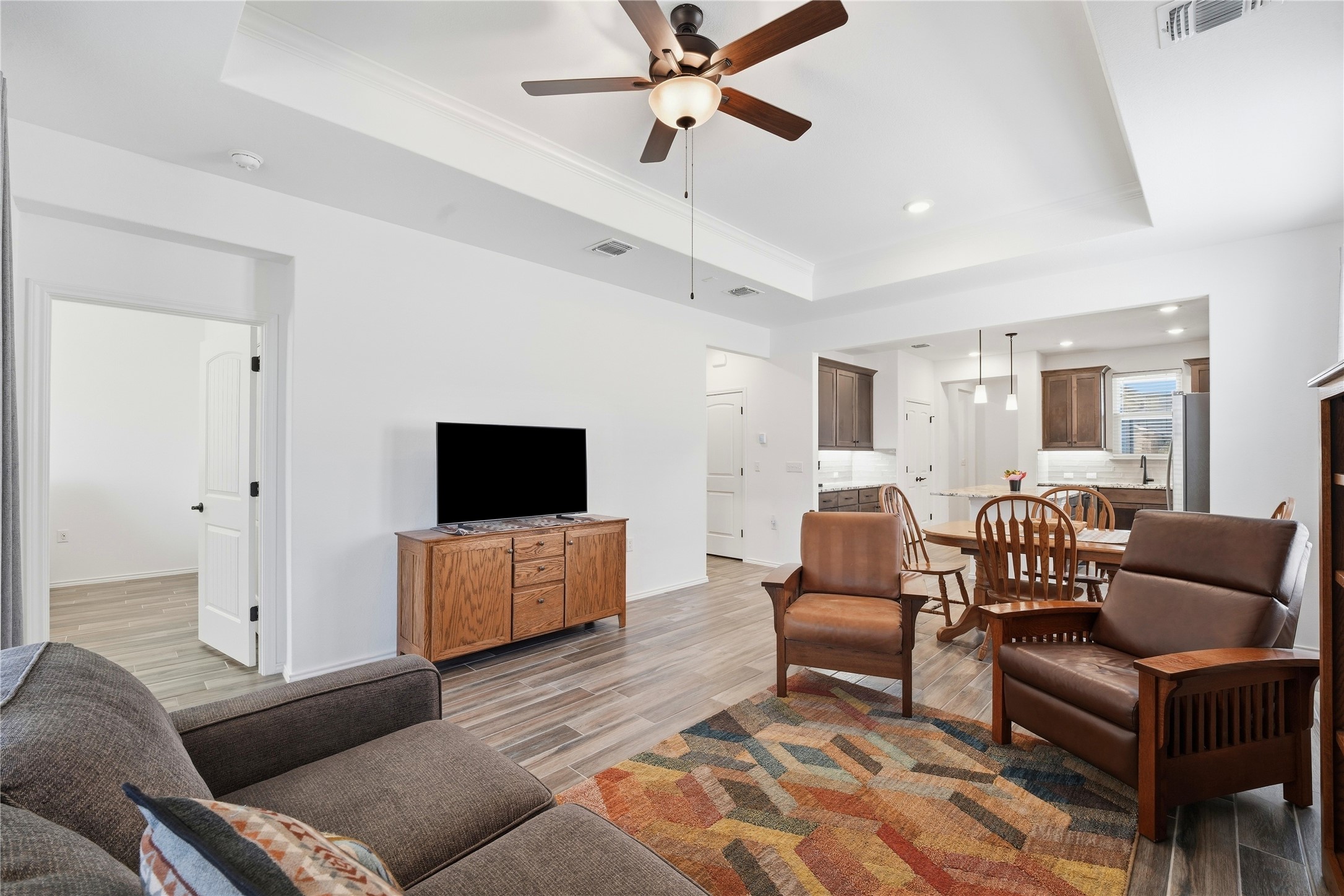122 Clay Hl Street Georgetown, TX 78633 - Photo 4 of 31 Living area with a raised ceiling, light wood finished floors, ceiling fan, and recessed lighting