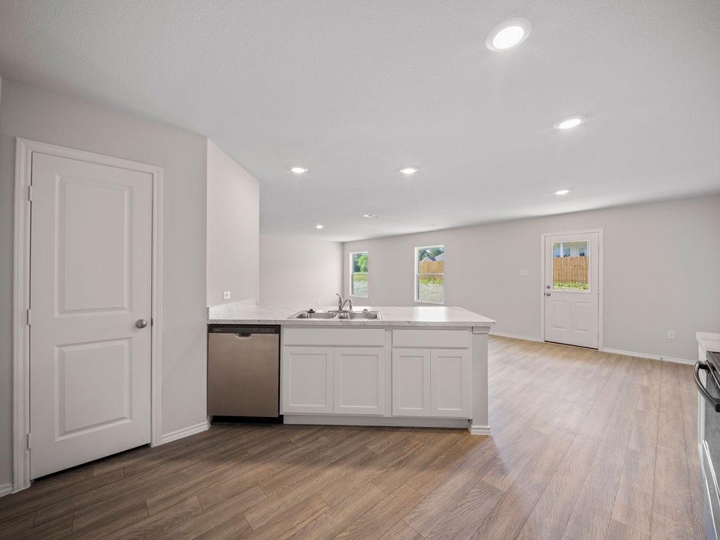 218 Stoney Ridge Lufkin, TX 75904 - Photo 8 of 29 a kitchen with stainless steel appliances granite countertop a sink and cabinets with wooden floor