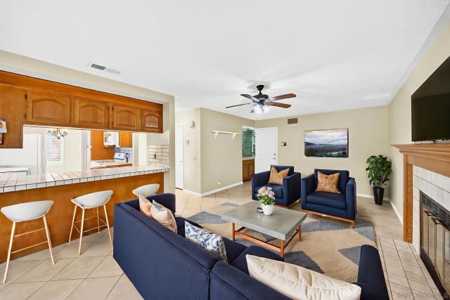 a view of an empty room with a fireplace and a window