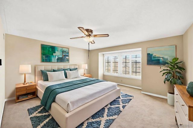 a view of room with a ceiling fan and window