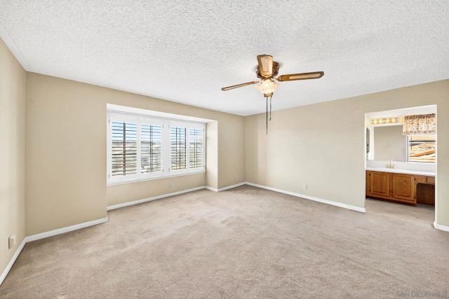 a view of an empty room with a ceiling fan