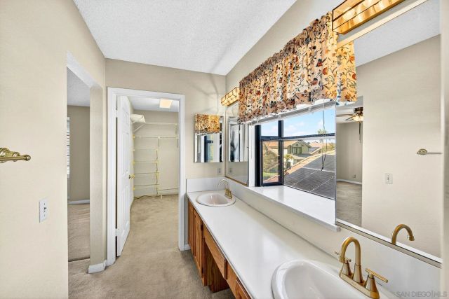 a view of a livingroom with a ceiling fan and window
