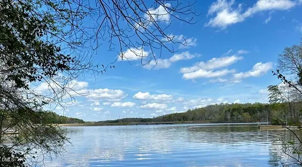 an aerial view of residential houses with outdoor space and lake view