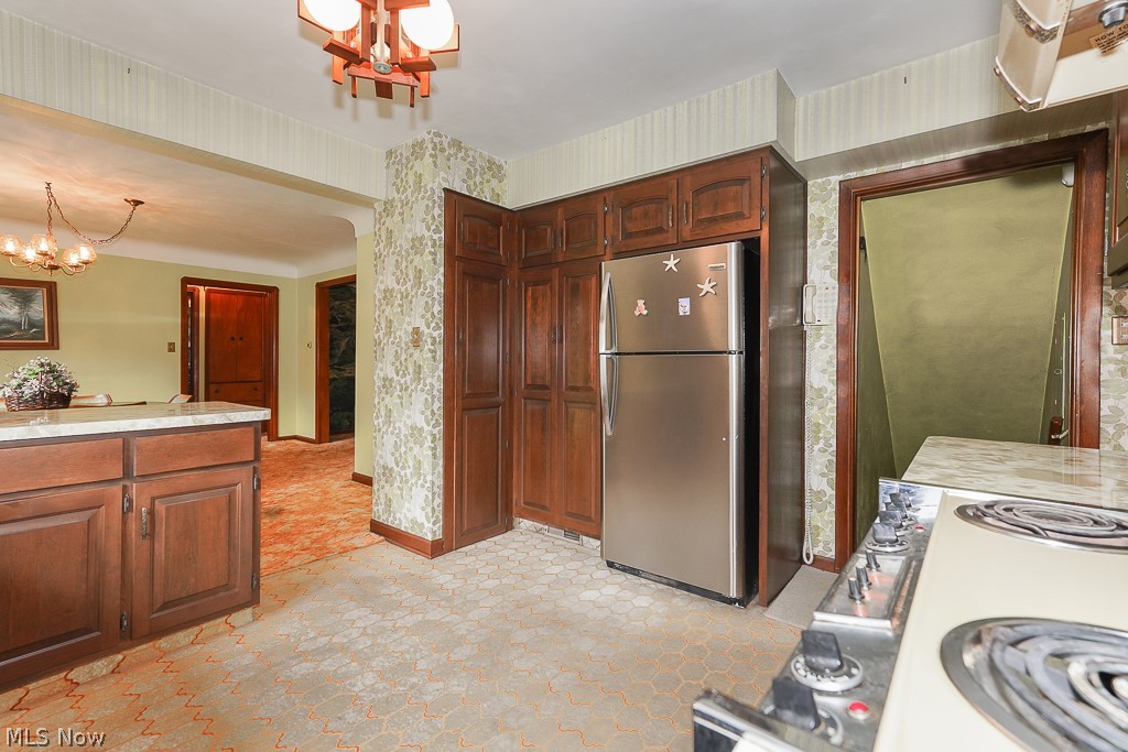 13028 Root Road Columbia Station, OH 44028 - Photo 17 of 35 Kitchen featuring hanging light fixtures, a chandelier, light tile floors, and stainless steel refrigerator