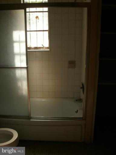 9612 Livingston Road Fort Washington, MD 20744 - Photo 12 of 13 a bathroom with a window a toilet and a window