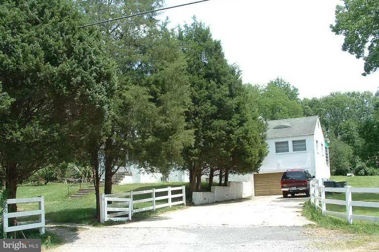 9612 Livingston Road Fort Washington, MD 20744 - Photo 13 of 13 a view of a house with a large tree and a yard