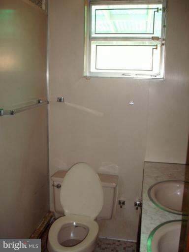 9612 Livingston Road Fort Washington, MD 20744 - Photo 9 of 13 a white toilet sitting in a bathroom next to a window