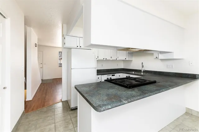 a kitchen with kitchen island a sink stove and refrigerator