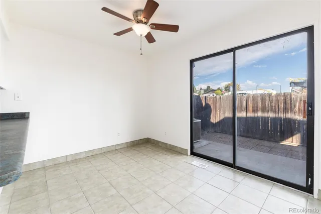 a view of a room with a ceiling fan