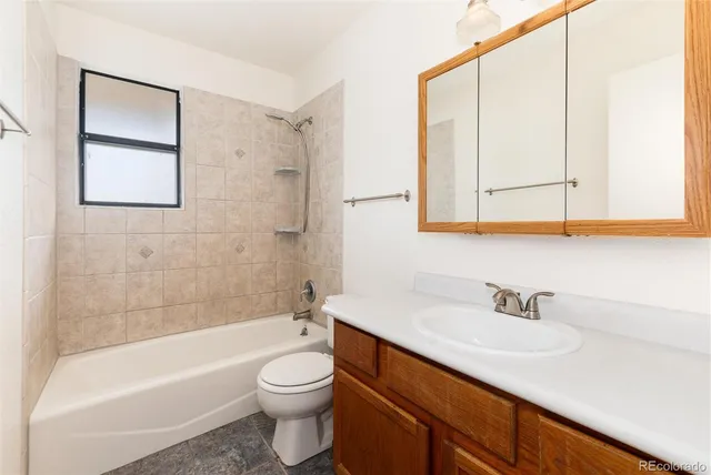 a bathroom with a sink a toilet and bathtub