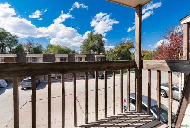 a view of a balcony with wooden floor and city view