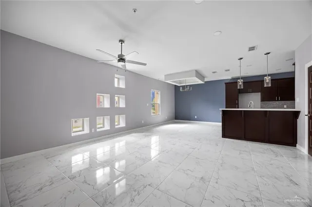 a kitchen with stainless steel appliances a refrigerator and a cabinets