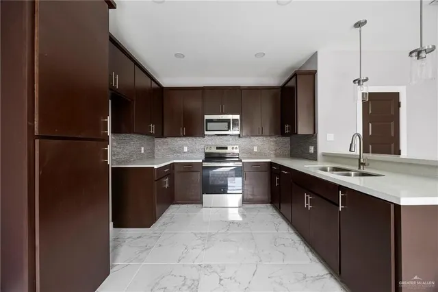 a kitchen with a sink stainless steel appliances and cabinets