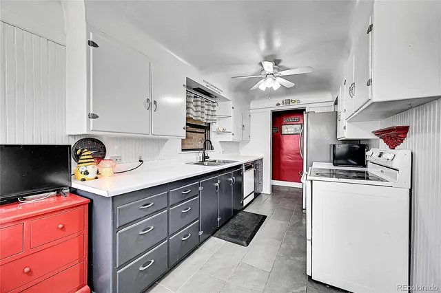 a kitchen with cabinets a sink and appliances