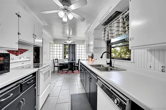 a kitchen with a sink stainless steel appliances a counter space and a window