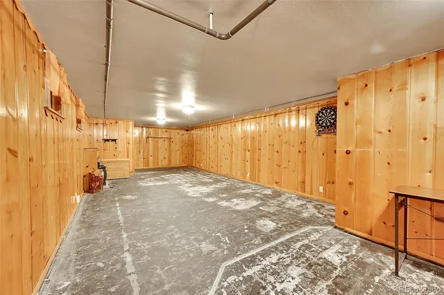 a view of a hallway with wooden floor and a bathroom