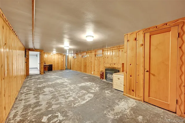 a view of a hallway with wooden shelves