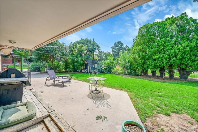a view of a backyard with sitting area