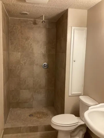 a white toilet sitting next to a bathroom sink