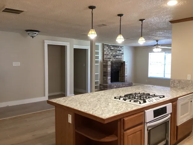a kitchen with a stove and a kitchen view