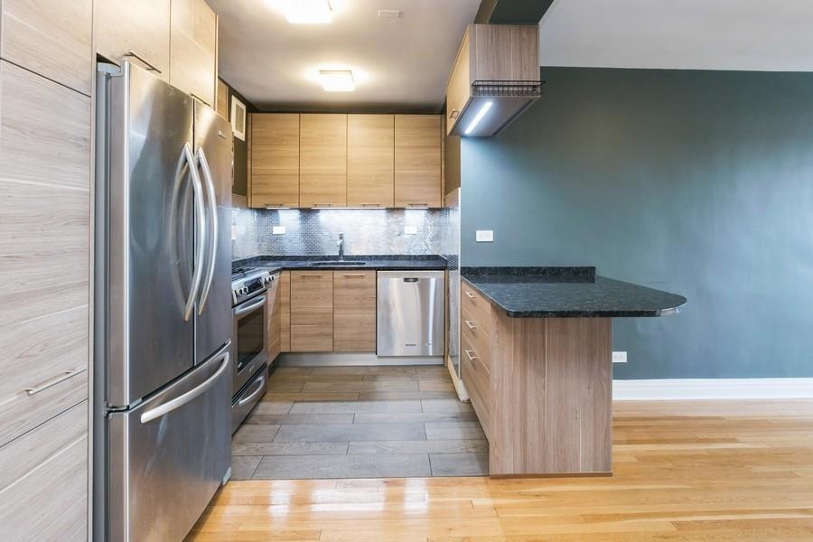 8301 Ridge Boulevard, Unit 6D Brooklyn, NY 11209 - Photo 5 of 23 a kitchen with stainless steel appliances granite countertop a sink a stove and a refrigerator