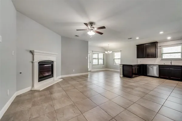 a view of a kitchen with a stove cabinets a fireplace and a chandelier