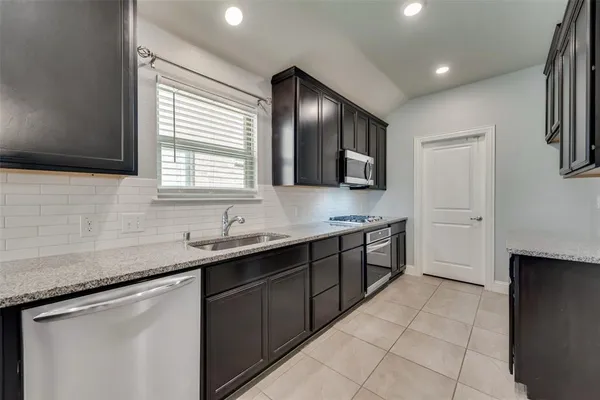 a kitchen with a sink cabinets and window