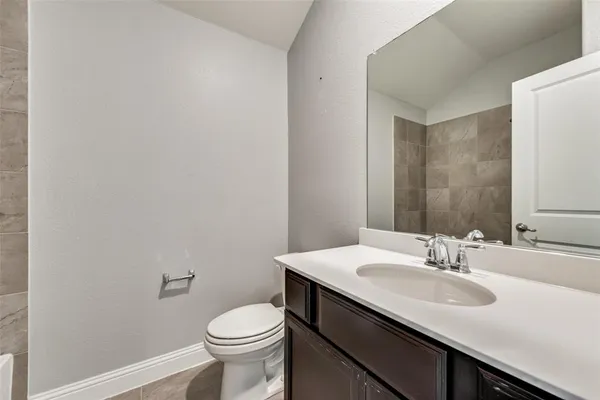 a bathroom with a sink toilet and a mirror