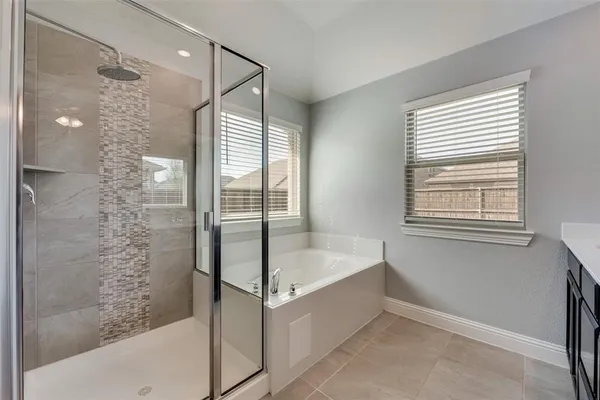 a bathroom with a bathtub and a shower