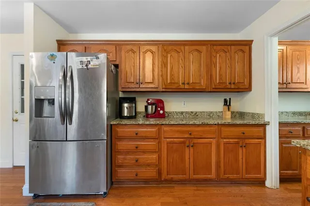 a kitchen with stainless steel appliances granite countertop a refrigerator and a sink
