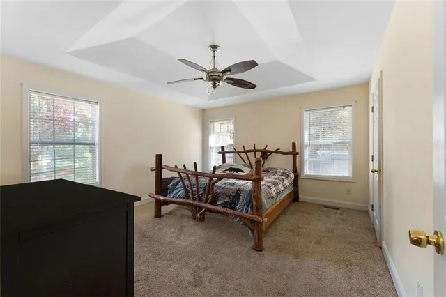 a spacious bedroom with a bed and a window