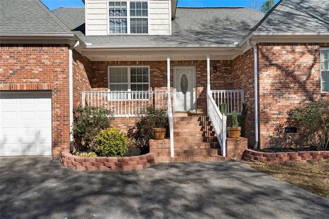 a front view of a house with a garden